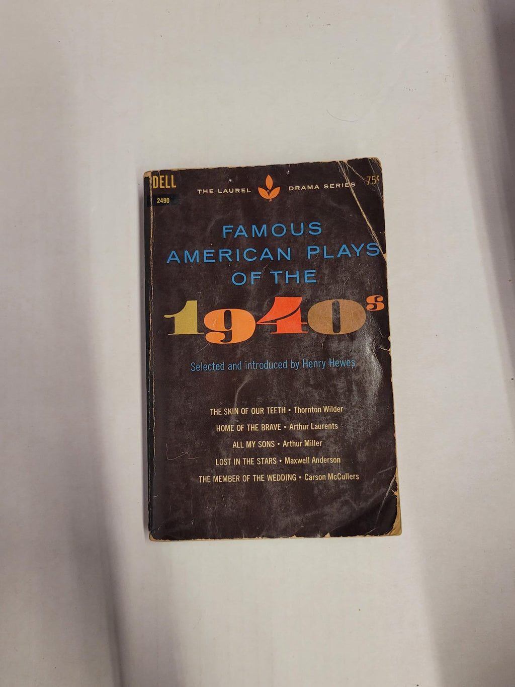 A vintage paperback book titled "Famous American Plays of the 1940s" by Dell, photographed on a light off-white surface with shadows.