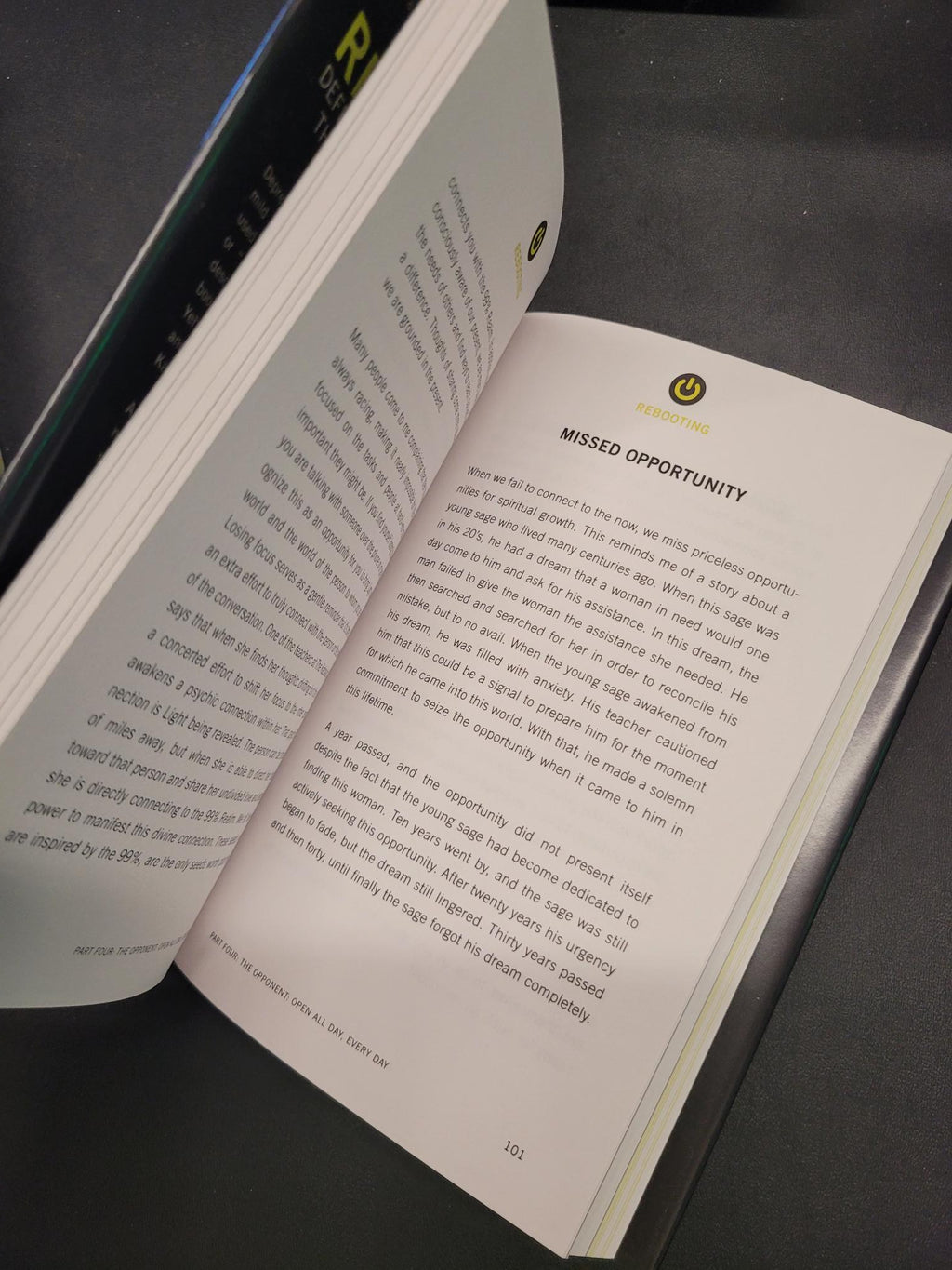 An open book showing printed text pages, photographed at an angle against a dark background.