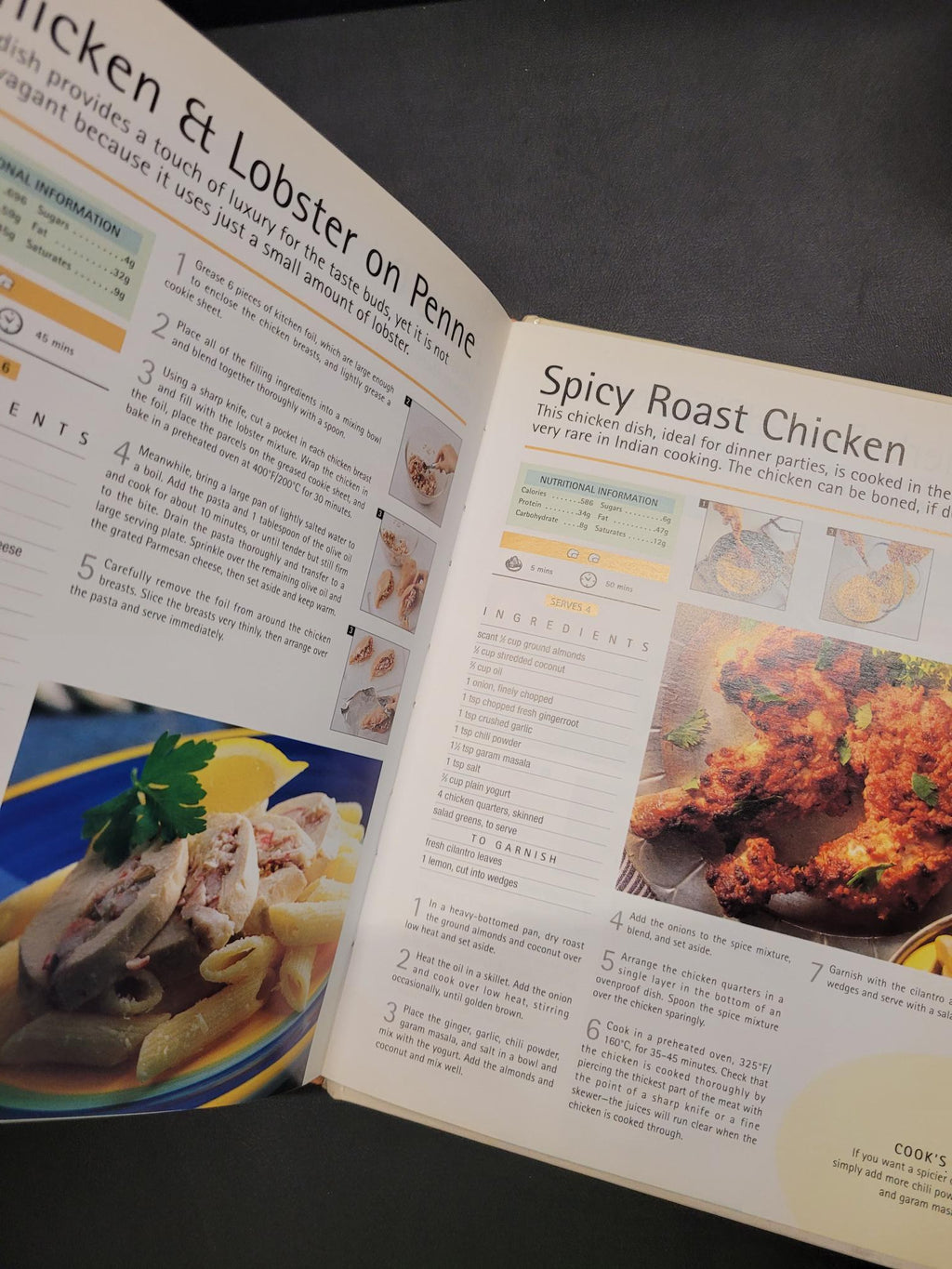 An open cookbook spread showing recipe pages with text, ingredient lists, and food photographs, photographed on a dark gray surface.