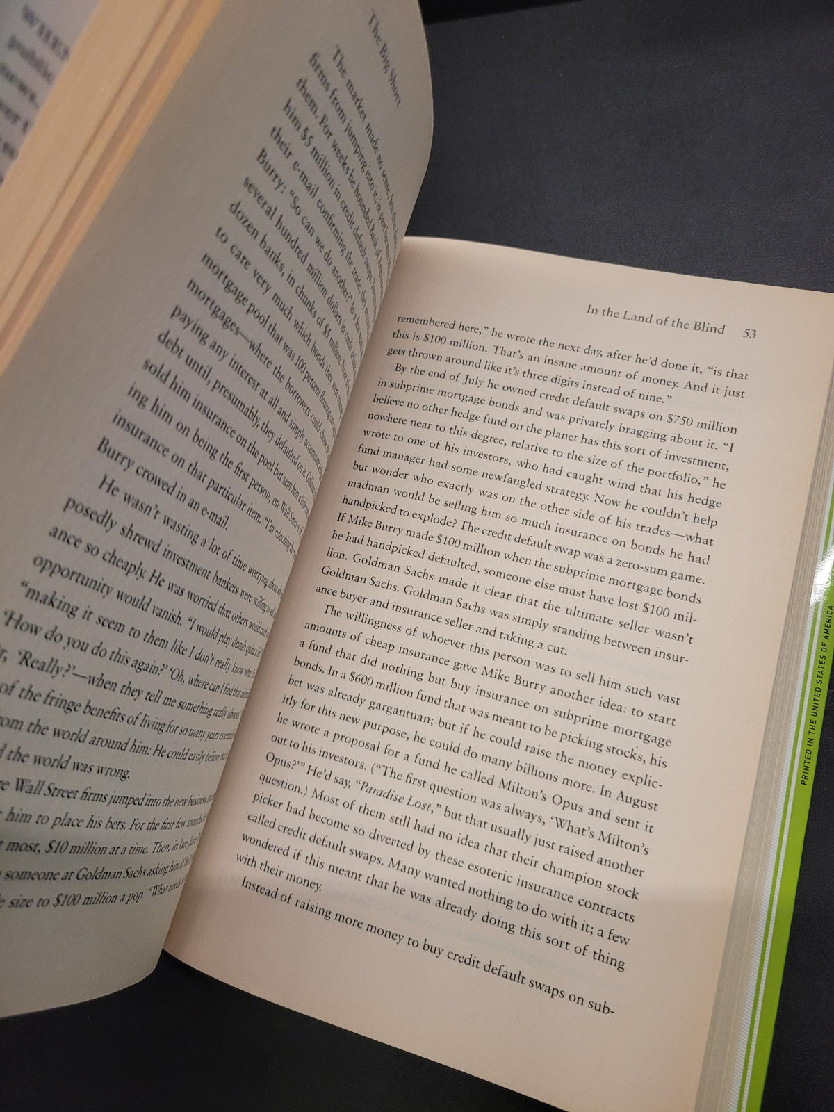 An open book showing printed text on cream-colored pages, photographed from above against a dark background.