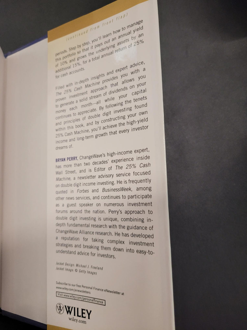 A printed informational card or insert from Wiley, photographed at an angle against a dark surface. The card contains small black text and a yellow vertical band on the left side.