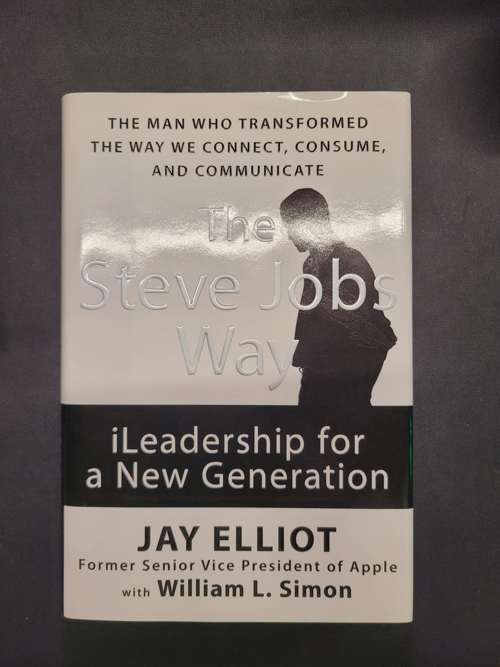 The Steve Jobs Way: iLeadership for a New Generation book by Jay Elliot with William L. Simon, featuring a black and white cover design with a silhouette of Steve Jobs.