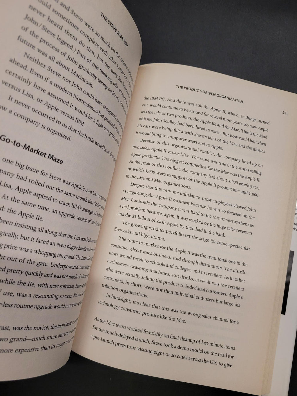 An open book showing printed text on both pages, photographed against a dark background.