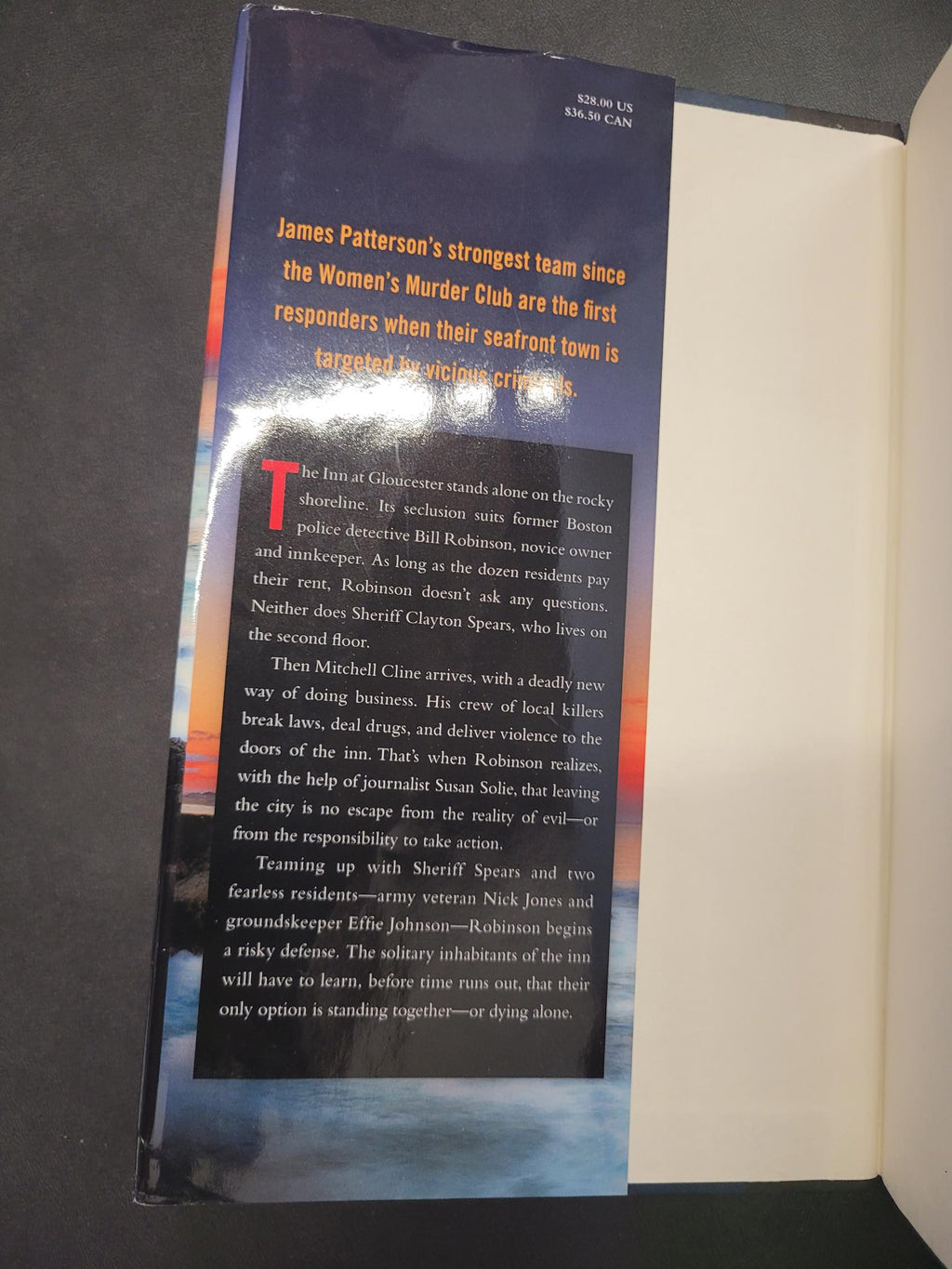 An open book showing the interior pages and a printed page with a large black text block, yellow title text, and a blue background.