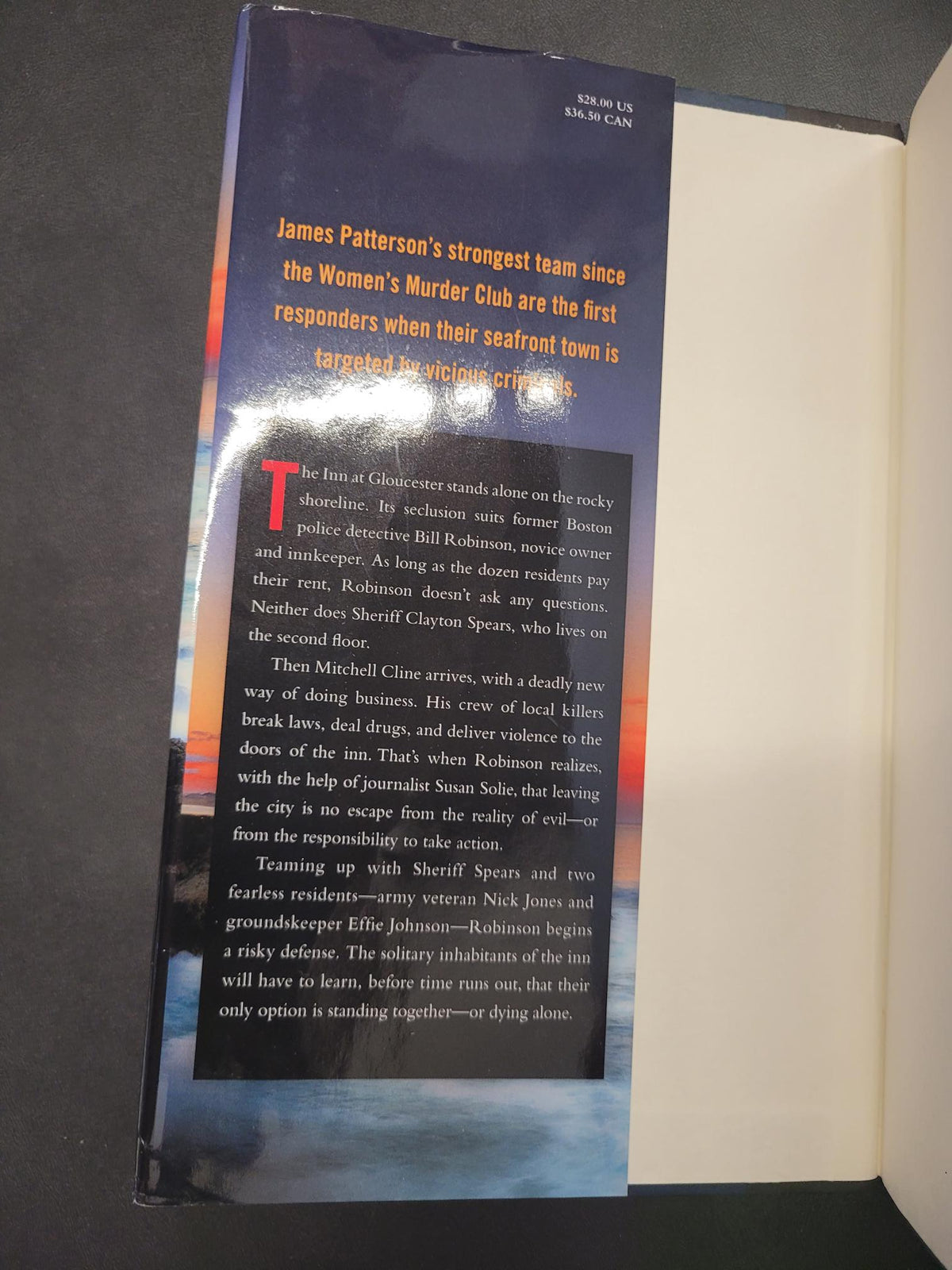 An open book showing the interior pages and a printed page with a large black text block, yellow title text, and a blue background.