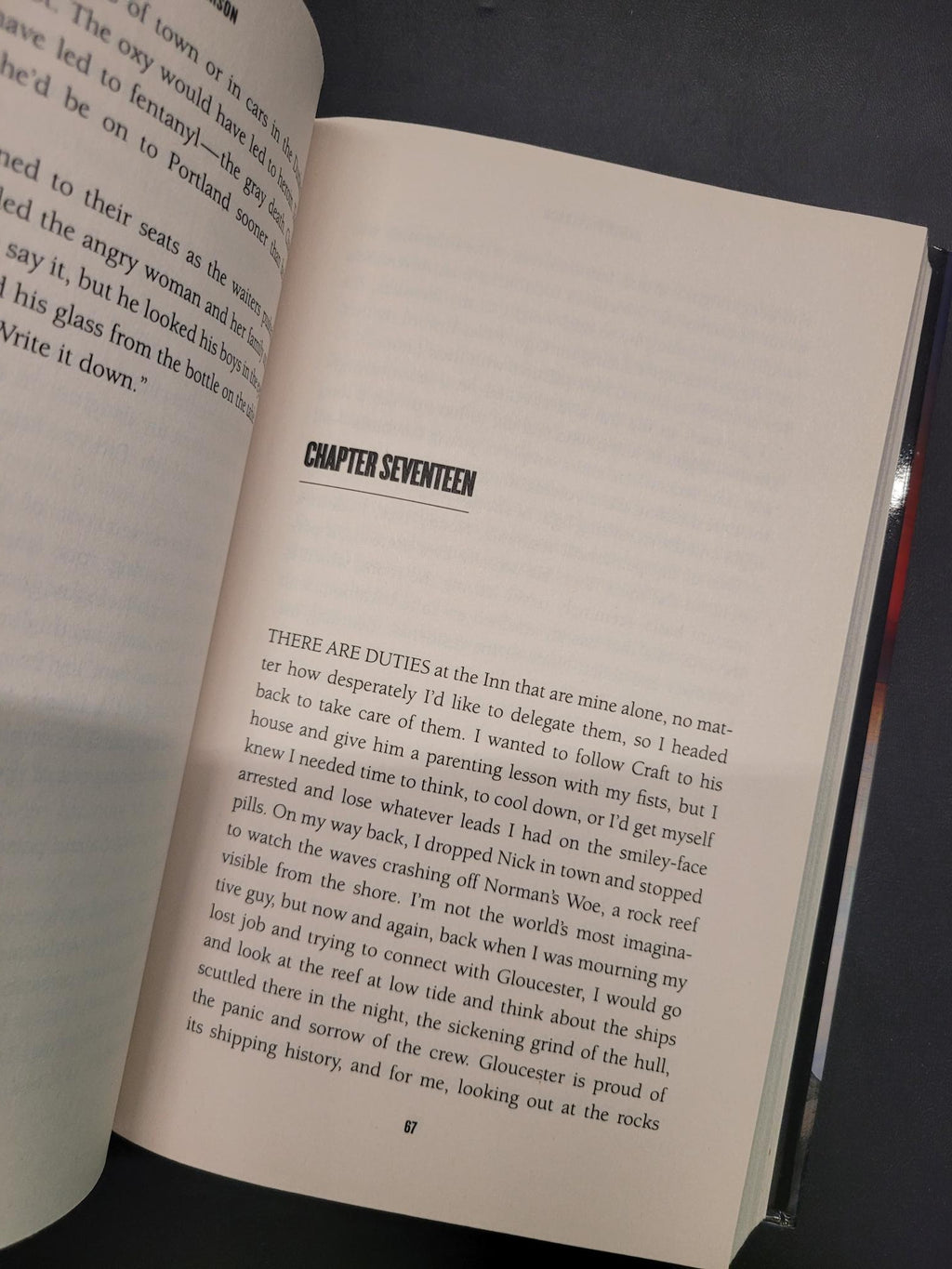 An open book showing printed text on two pages, photographed from above on a dark surface. The right page has a visible chapter heading reading 'CHAPTER SEVENTEEN'.