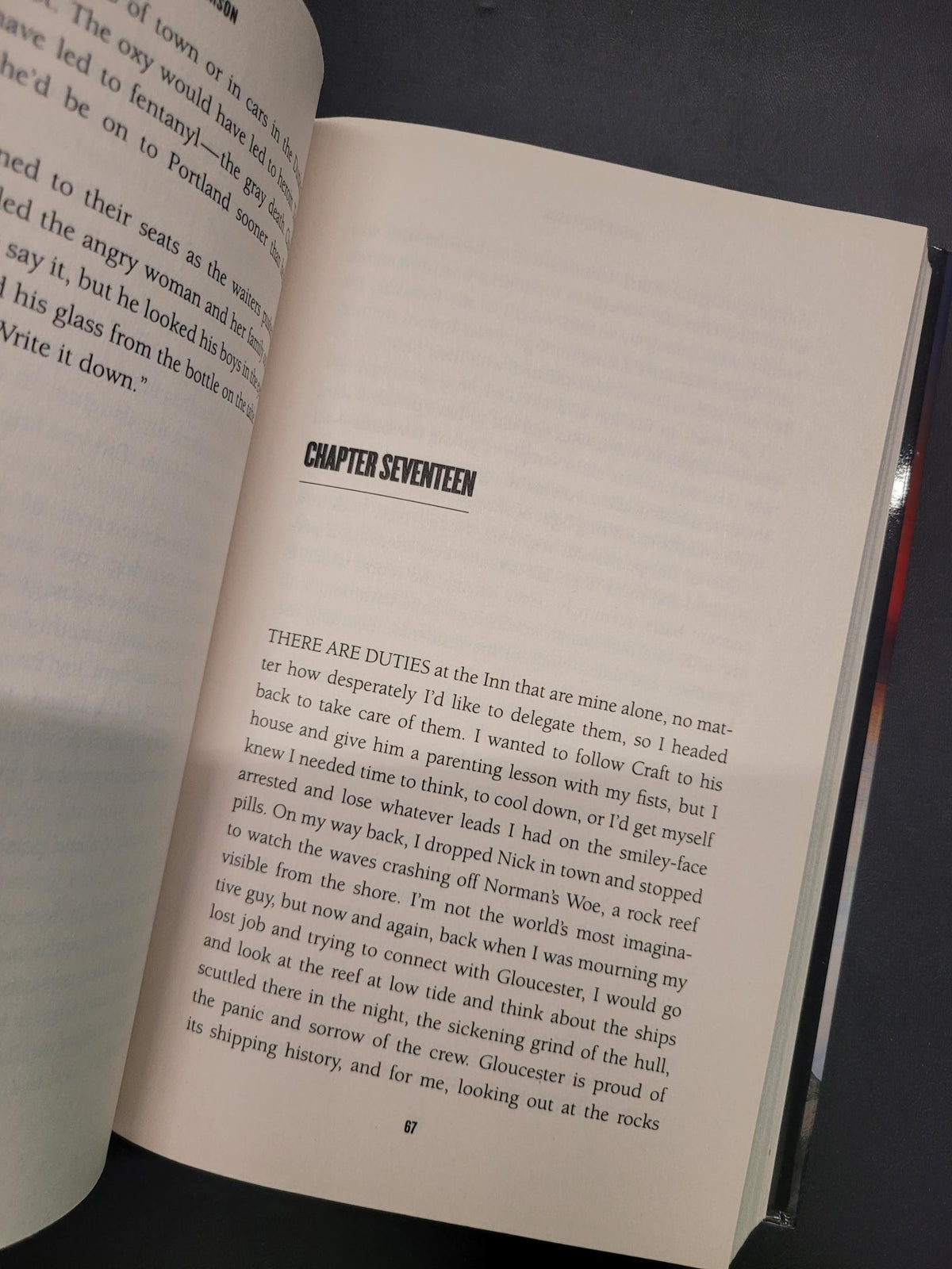 An open book showing printed text on two pages, photographed from above on a dark surface. The right page has a visible chapter heading reading 'CHAPTER SEVENTEEN'.