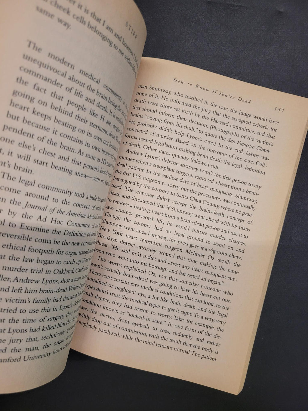 An open book showing printed text on two cream-colored pages against a dark background.