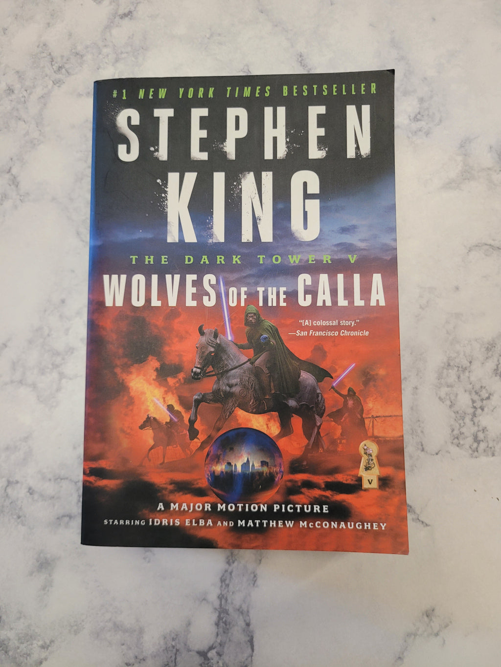 Stephen King's 'The Dark Tower V: Wolves of the Calla' book cover, displayed flat on a white and gray marble surface.