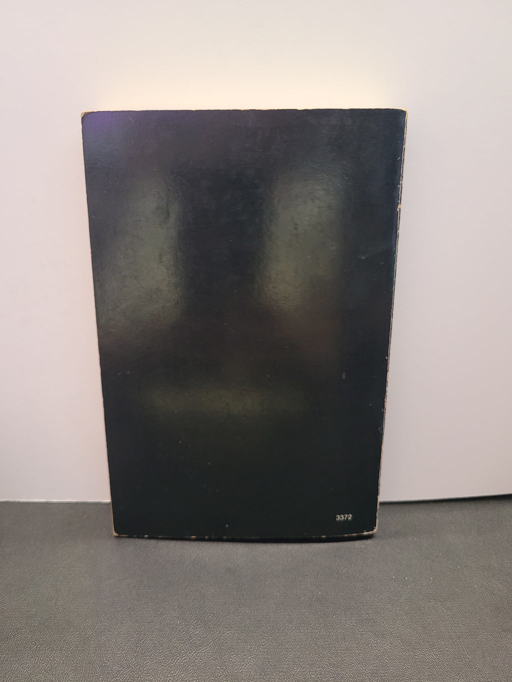 The plain black cover of the back of the book "Black African Voices."